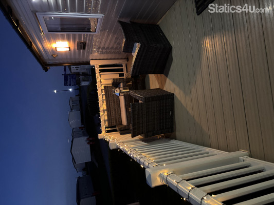 Large secure decking area with rattan furniture Large secure decking area with rattan furniture